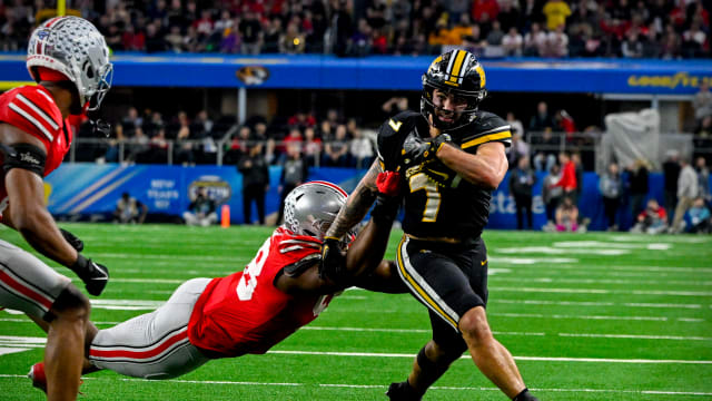 Missouri Tigers running back Cody Schrader (7) runs for a first down against the Ohio State Buckeyes during the fourth quarter at AT&T Stadium.